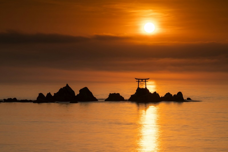 The sun is setting over a body of water